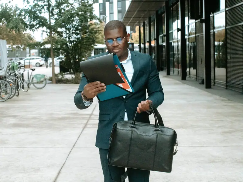 Homme d'affaires consultant une tablette devant des bureaux